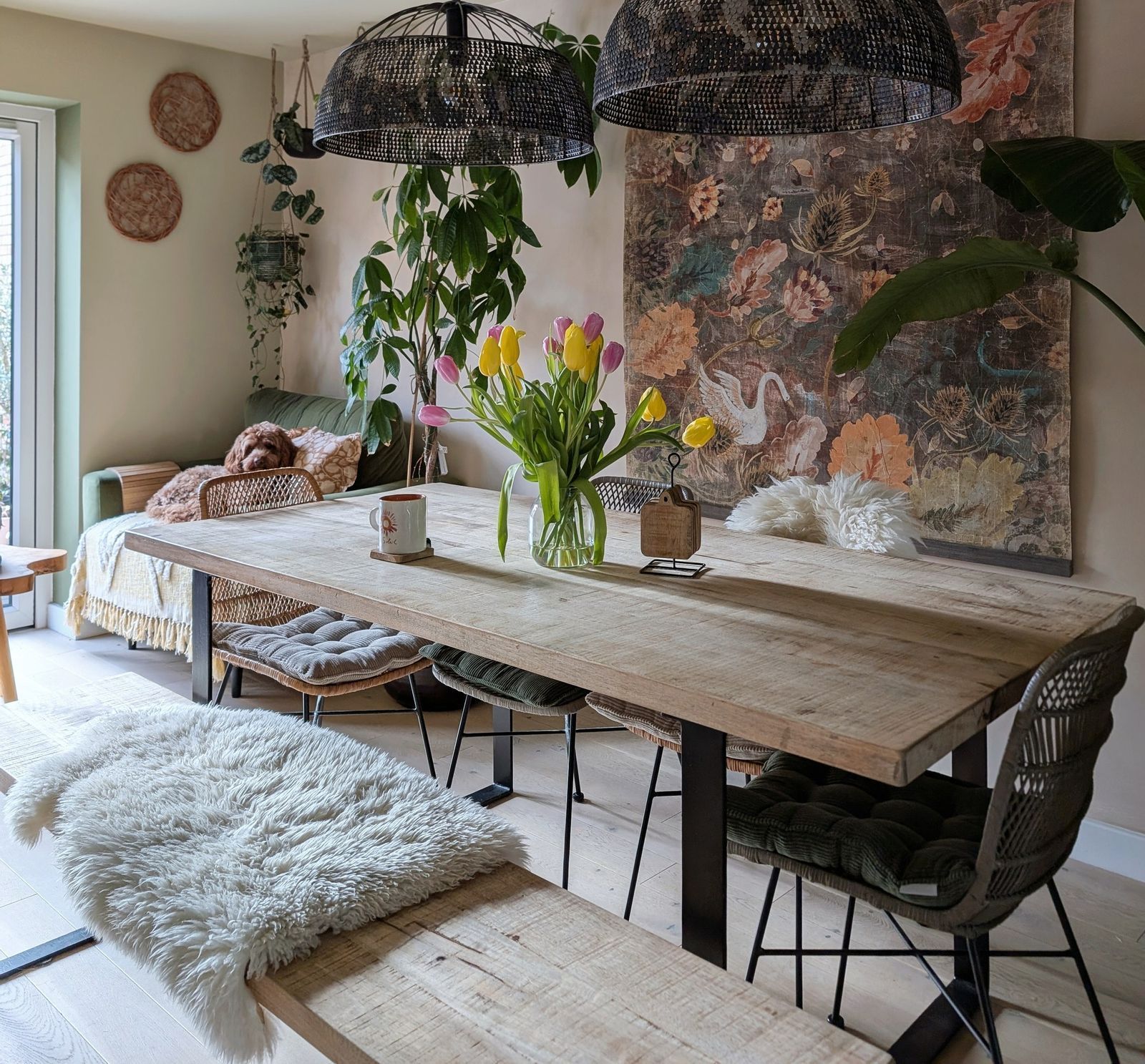 Styled dining room with tulips, pendant lights and botanical artwork