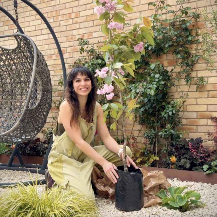 Marine in her garden with a cherry blossom tree